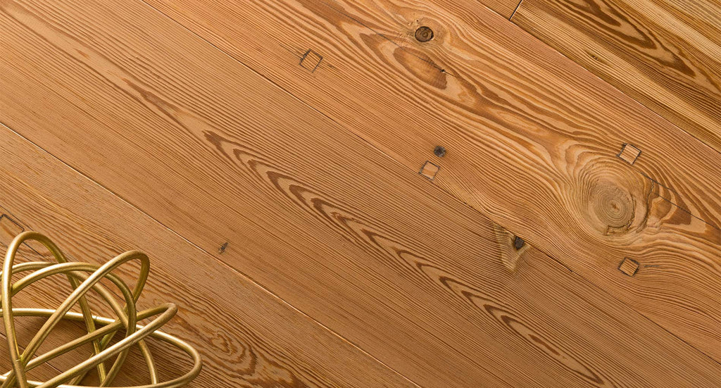 Sustainable hardwood flooring including reclaimed heart pine that has been upcycled from old buildings and shipped across Canada.
